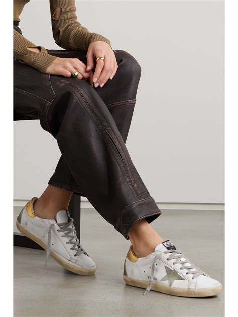 golden goose superstar distressed leather and suede sneakers.